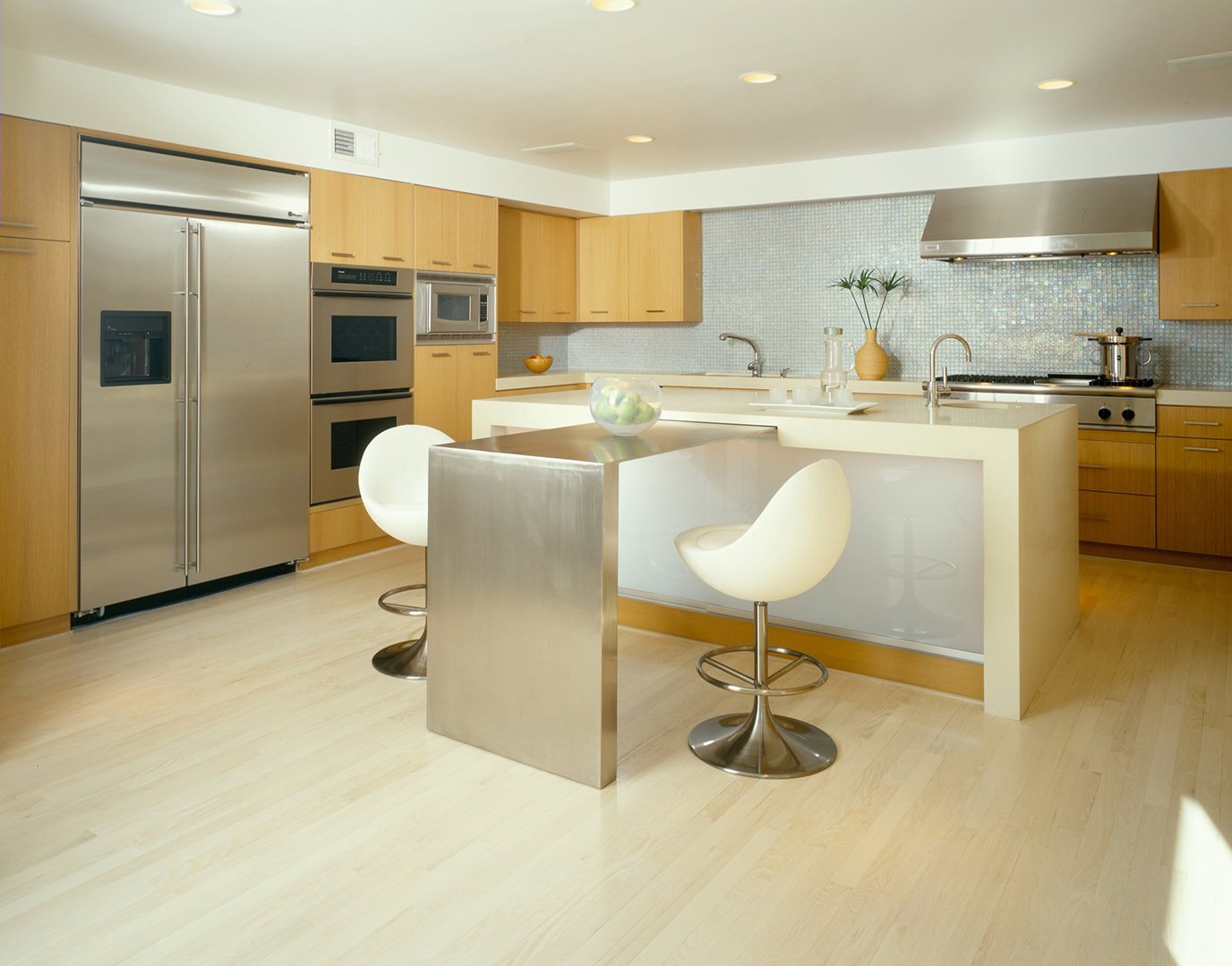 Kitchen of Mulholland Drive modern home featuring sleek appliances and unique island seating arrangement, full-service interior design by Stephen Pappas Interiors, Los Angeles