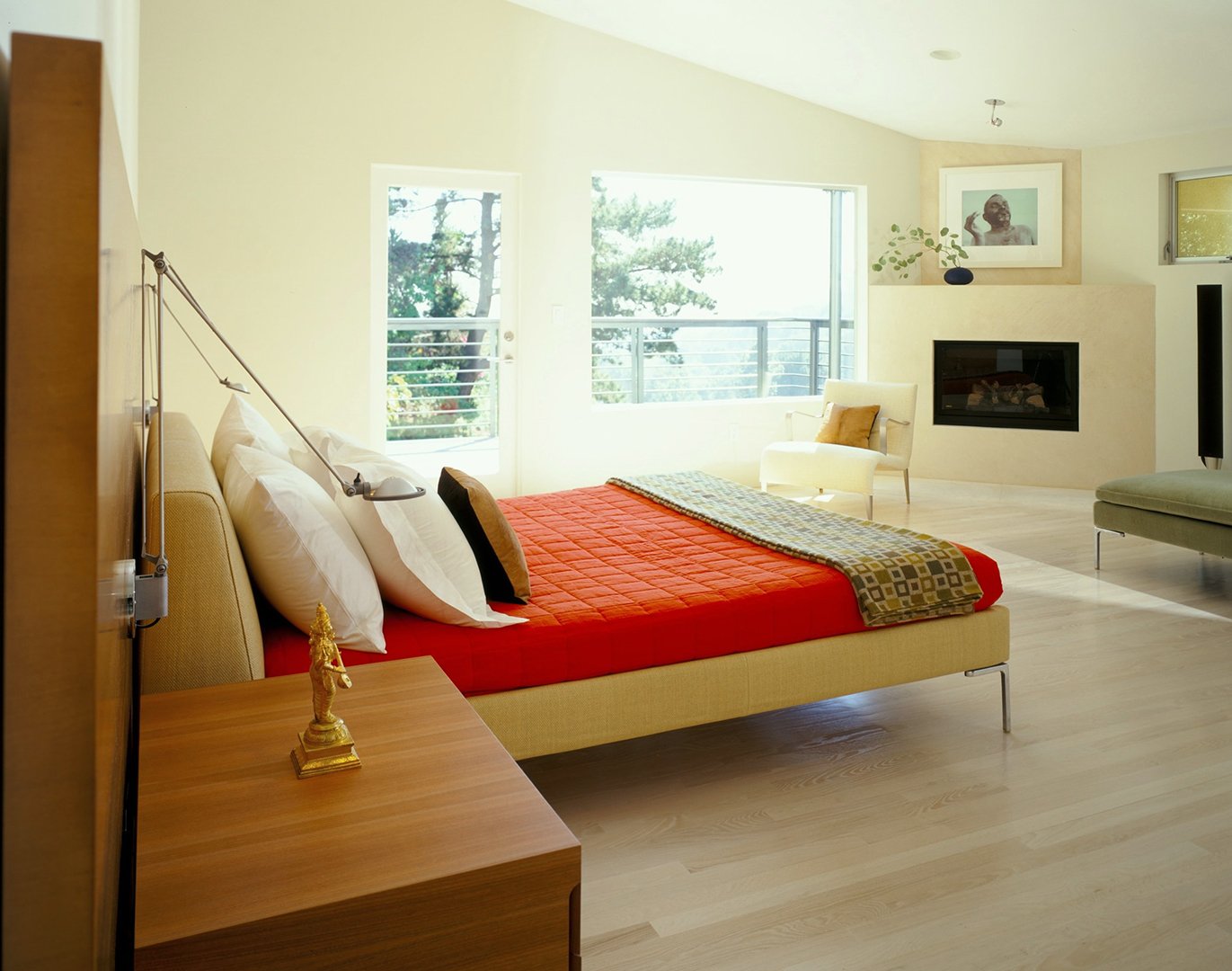 Bedroom of Mulholland Drive modern home featuring custom French limestone fireplace wall and minimalist bedding and furniture, full-service interior design by Stephen Pappas Interiors, Los Angeles