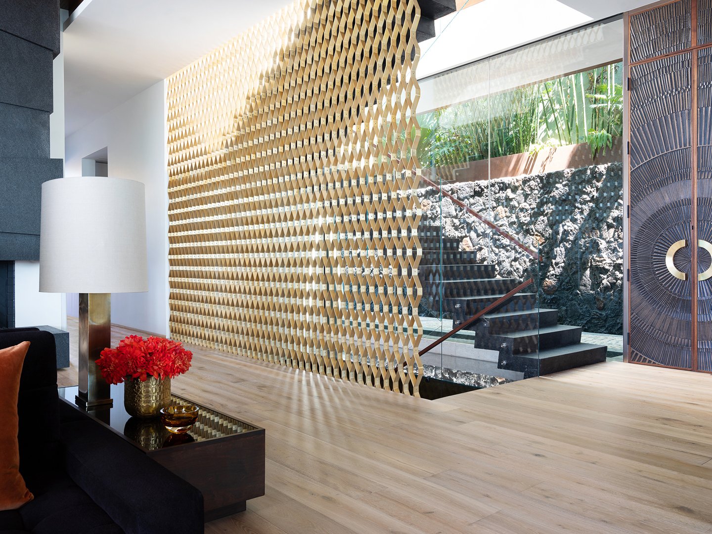 Interior styling of a luxury entry way and stairwell for California Classic Floors featuring modern lighting and accents, and a unique lattice wall styled by Stephen Pappas Interiors, photographed by Roger Davies