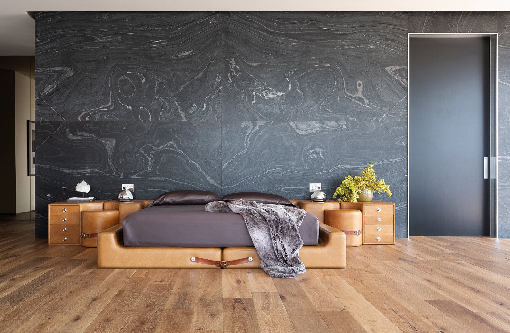 Interior styling of a modern bedroom for California Classic Floors featuring custom upholstery and a large black marble wall, styled by Stephen Pappas Interiors, photographed by Roger Davies