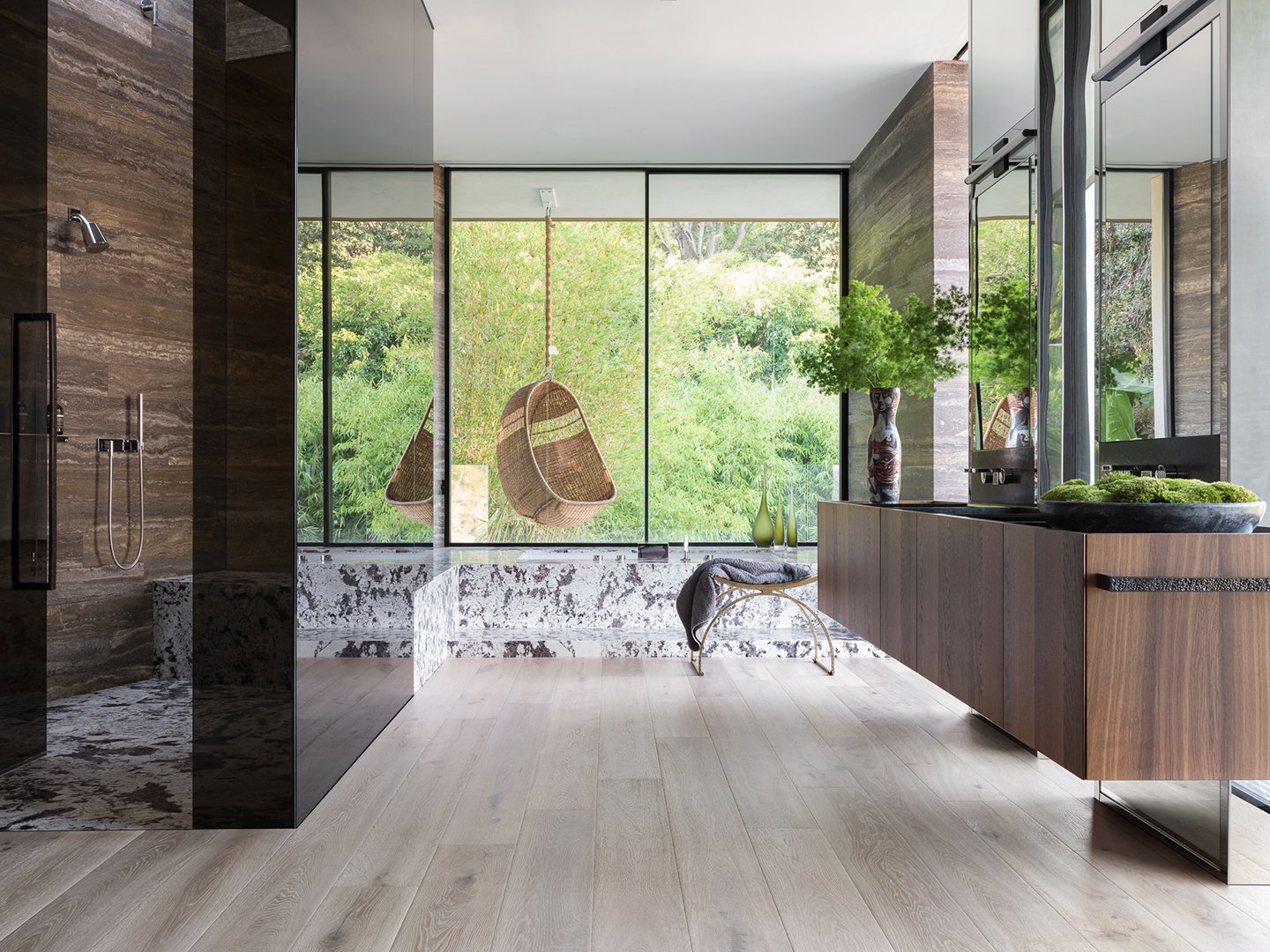 Interior styling of a luxury bathroom for California Classic Floors featuring a sleek open shower, a hanging wicker chair with elegant modern accents styled by Stephen Pappas Interiors, photographed by Roger Davies