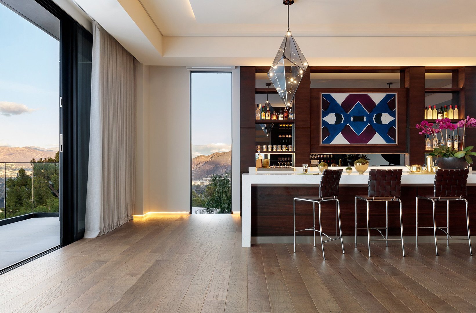 Interior styling of an open concept wet bar and kitchen for California Classic Floors featuring custom lighting and modern bar furniture and accents, styled by Stephen Pappas Interiors, photographed by Roger Davies