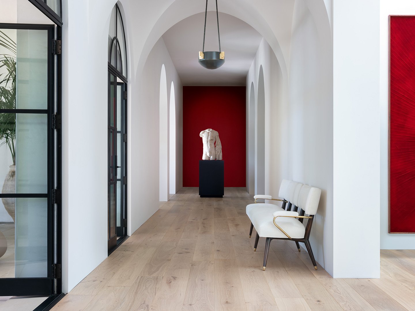 Interior styling detail of a hallway of a modern home for California Classic Floors featuring custom lighting, modern seating and a unique abstract sculpture, styled by Stephen Pappas Interiors, photographed by Roger Davies