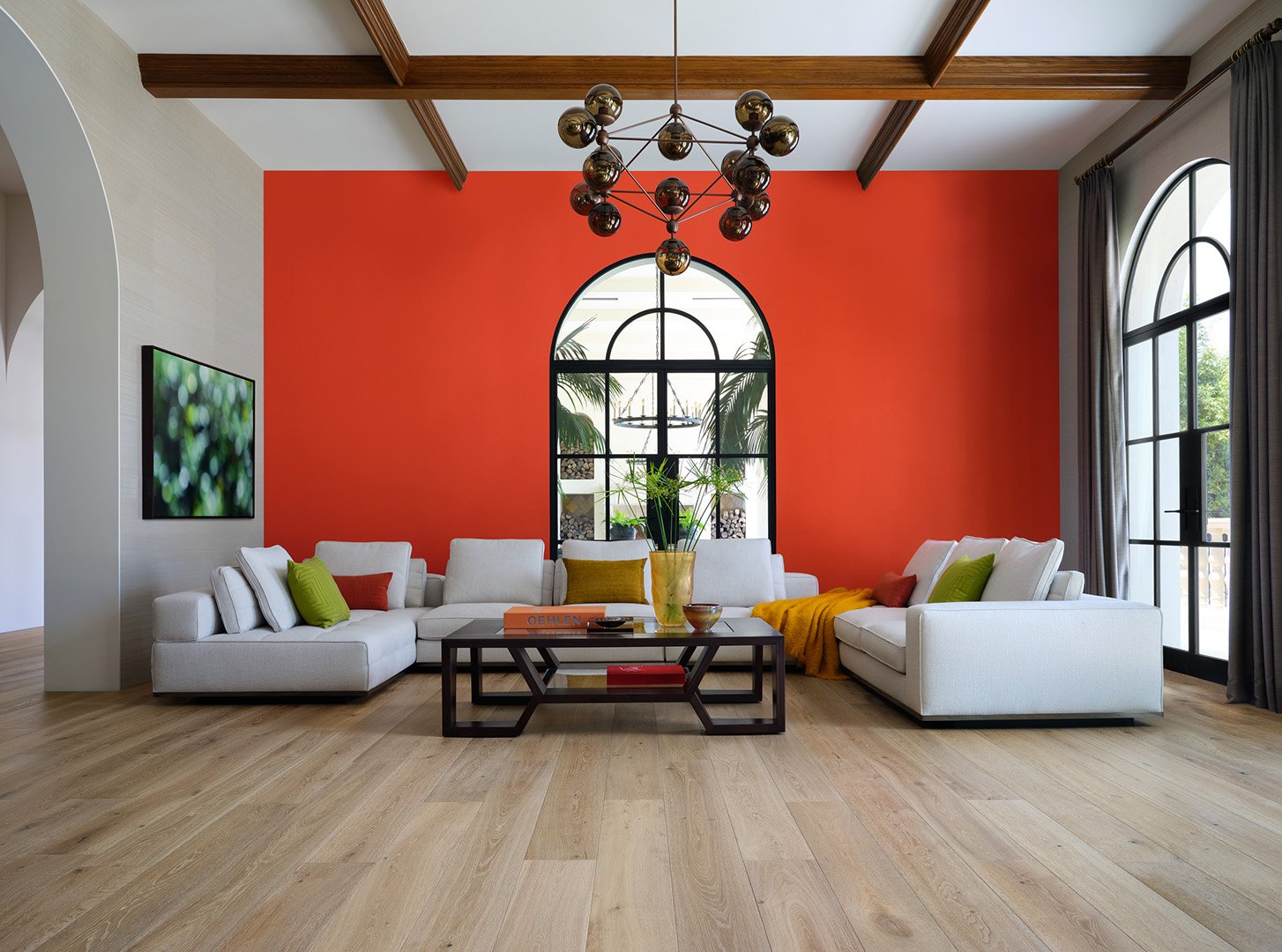 Interior styling of a modern living room for California Classic Floors featuring custom upholstered white sofa, tall arched windows and doorways, and custom overhead lighting, styled by Stephen Pappas Interiors, photographed by Roger Davies